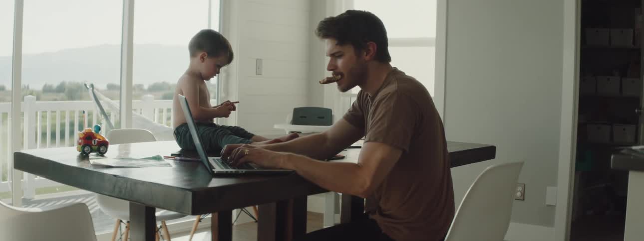 A father and son eat breakfast together