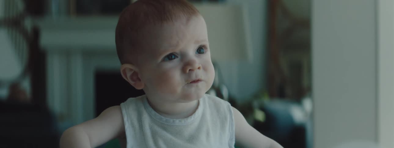 A baby that is eating food in a house