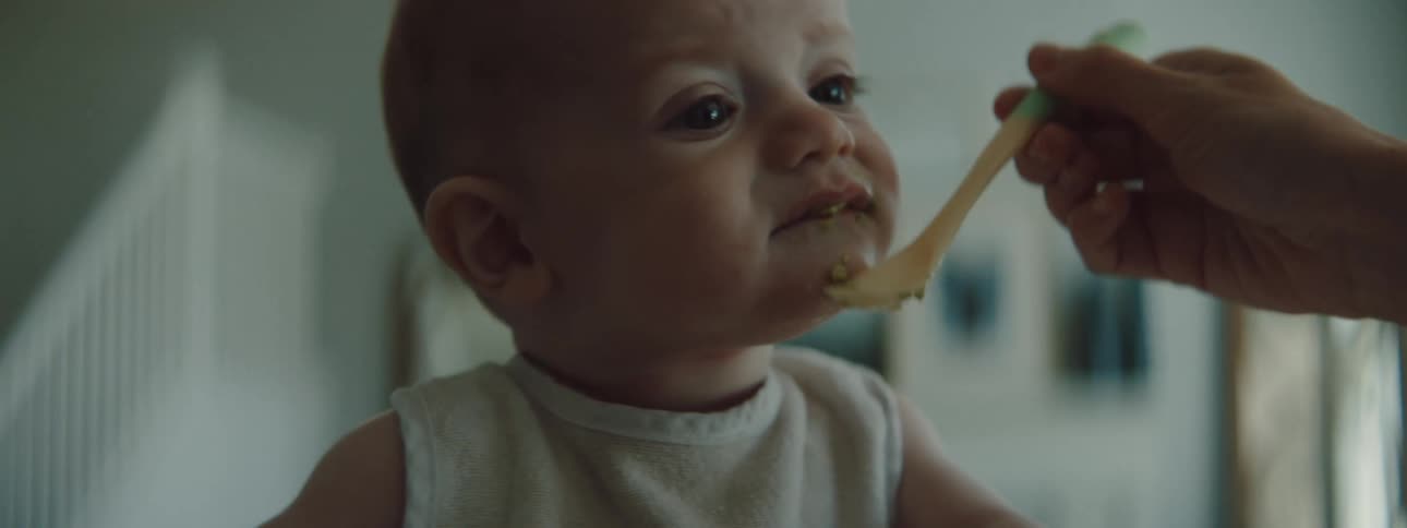 A baby being fed baby food indoors at home