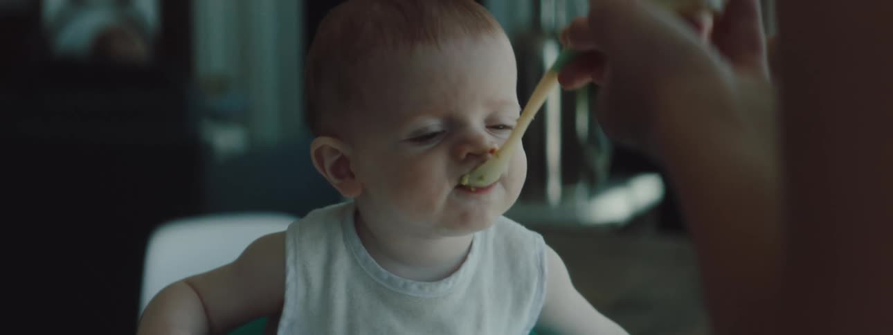 A baby is being fed at home