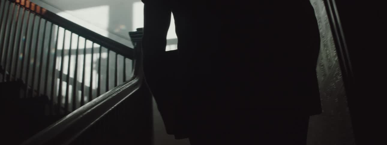 A man carries a box up stairs in a new home