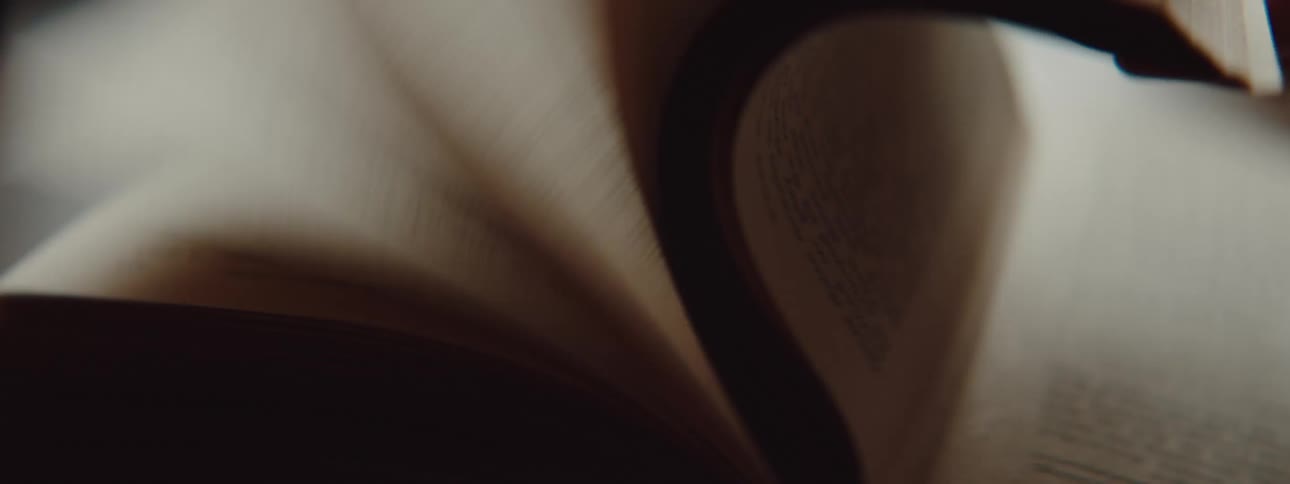 A person is flipping through pages in a book