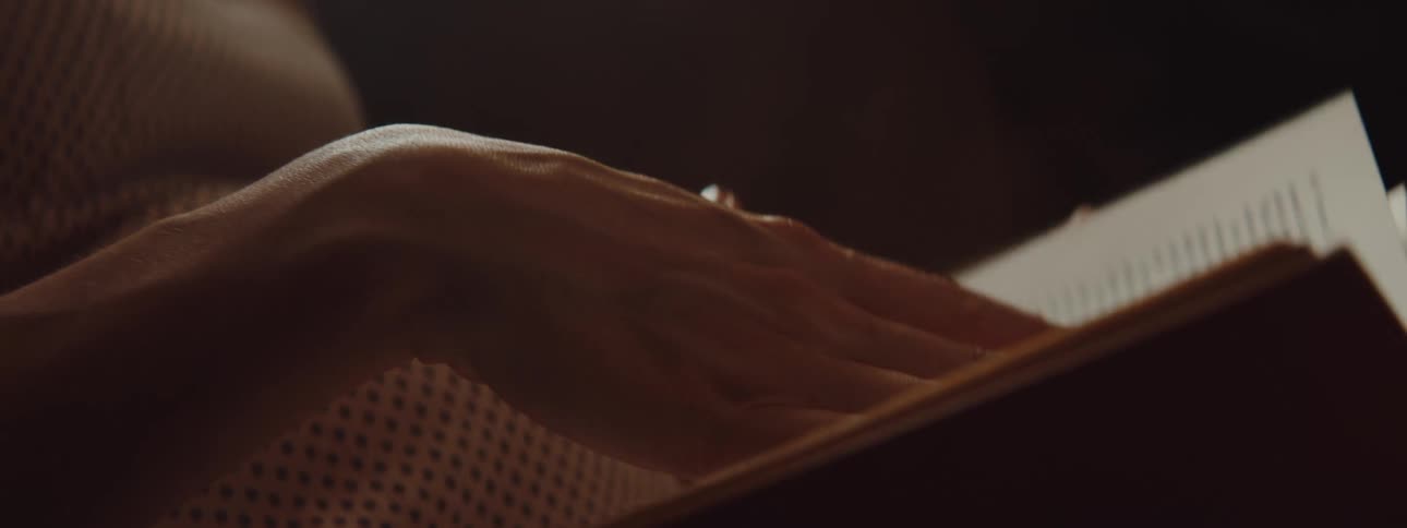 A girl is flipping through a books pages