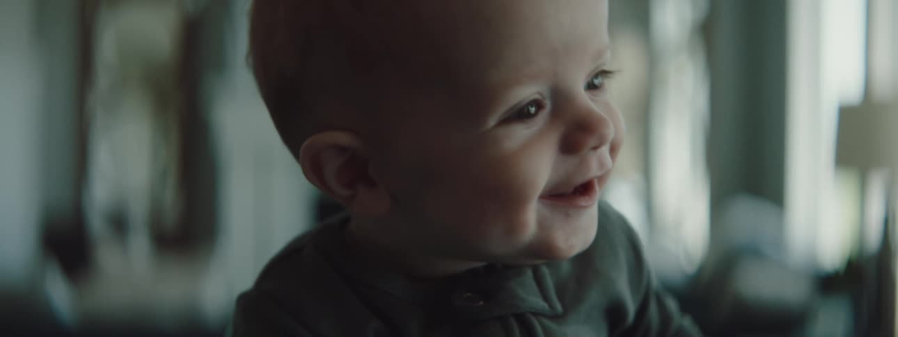 A baby is smiling and laughing