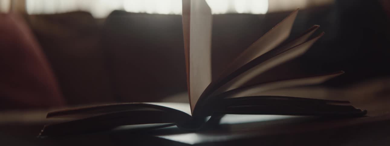 A book is laying on a table inside of a living room
