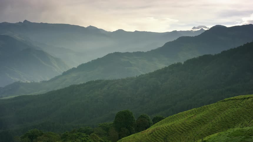 Rolling green hills with mountains and green vegetation