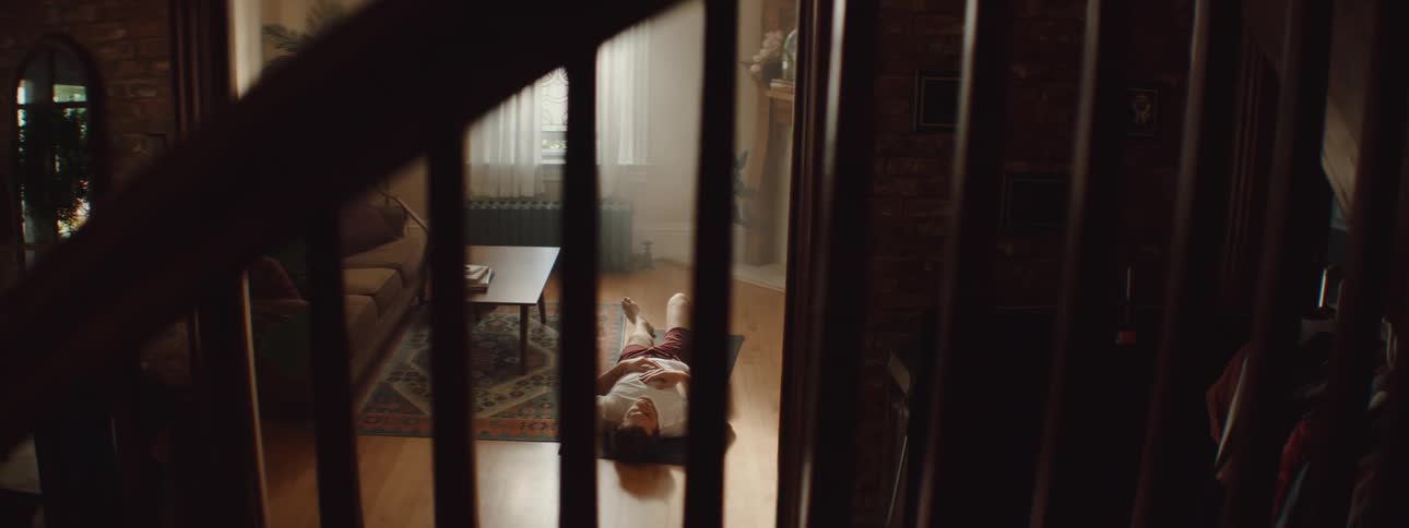 Man working out on the floor in the living room at home