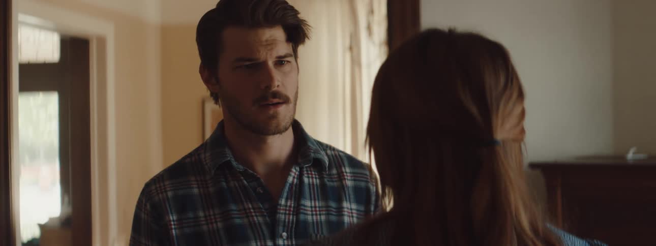 Husband and wife are standing inside their house and arguing