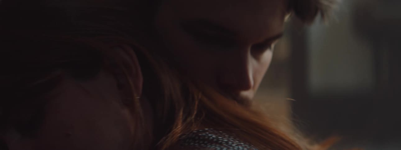 Man and woman cuddle each other and look into each others eyes