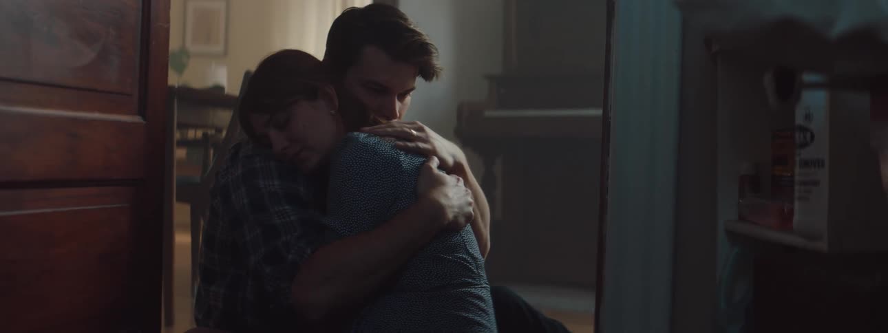 Young couple sitting on the floor consoling each other