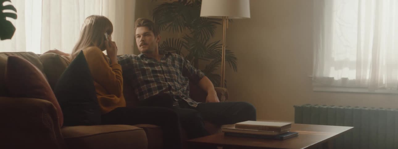 Husband and wife are sitting on a couch together