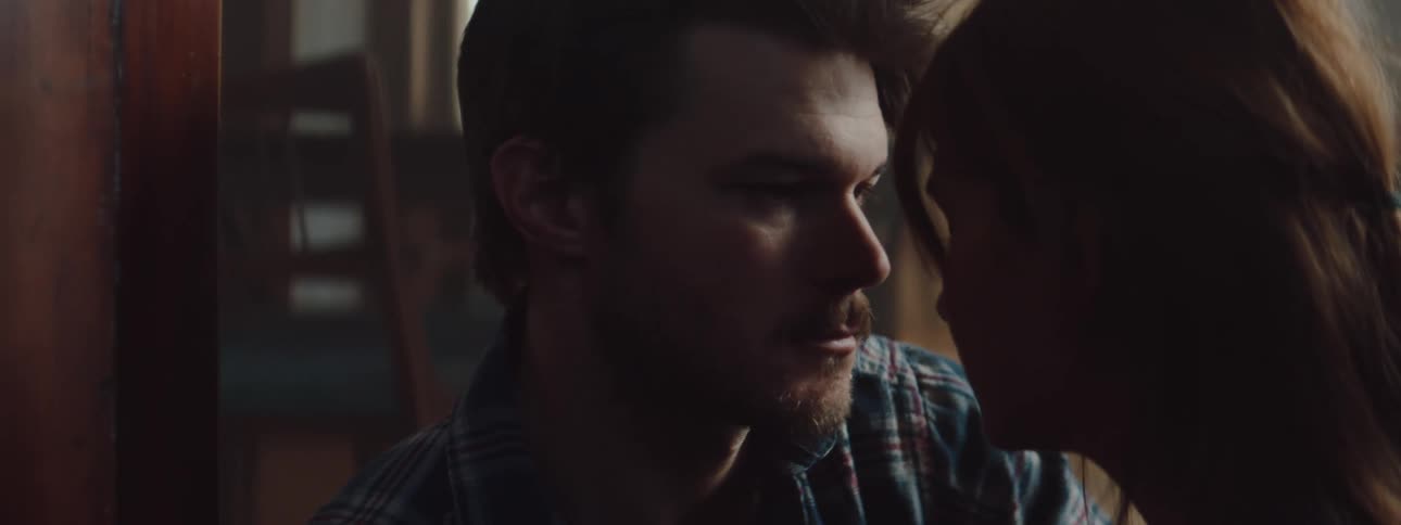 Man consoling his wife on the floor of the living room at home