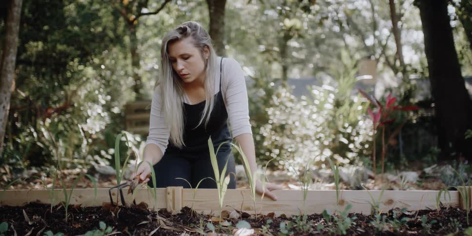 A woman is sitting outdoors and gardening in spring