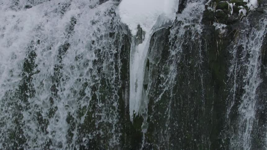 Slow motion static shot showing water droplets cascading downwards in this pleasing natural zen scene