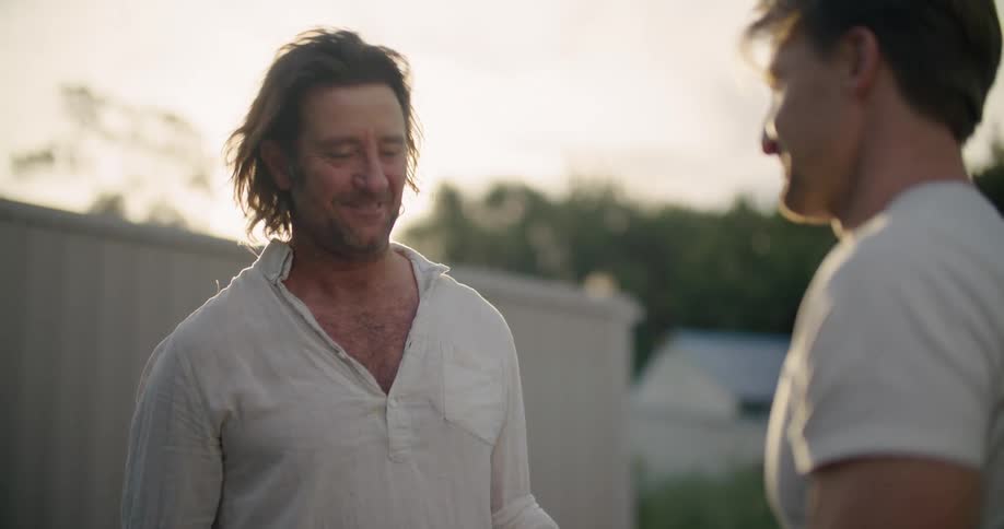 Two friends are standing outdoors in spring at dusk