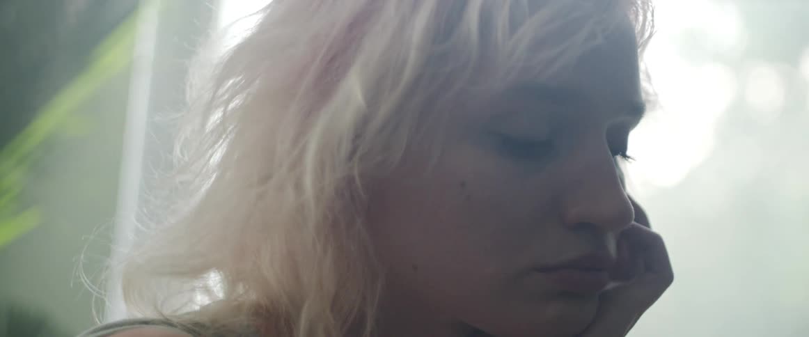 Side view of bored blonde woman looking around