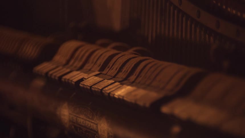 Keys are moving inside the mechanics of a piano
