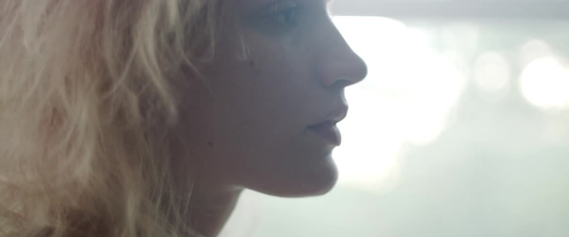 A woman in a room with a window in the background