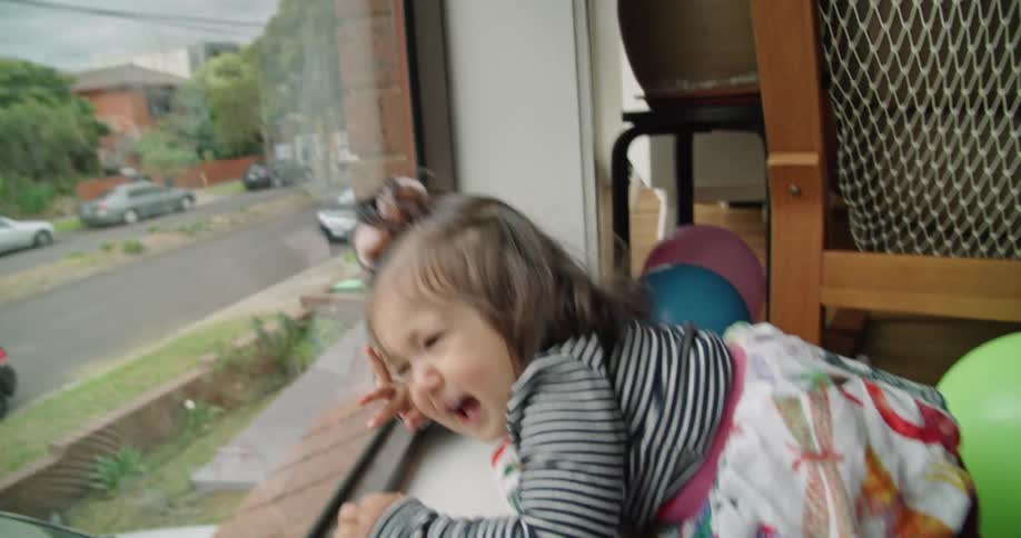 Girl looking out the window slips and falls and starts crying