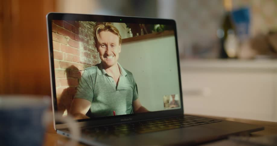 A person is talking on a laptop screen