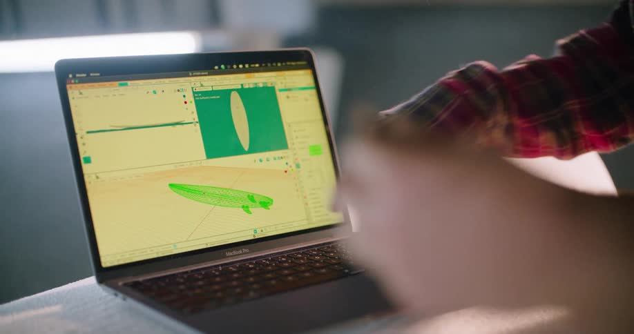 A person is looking at a laptop and sitting indoors