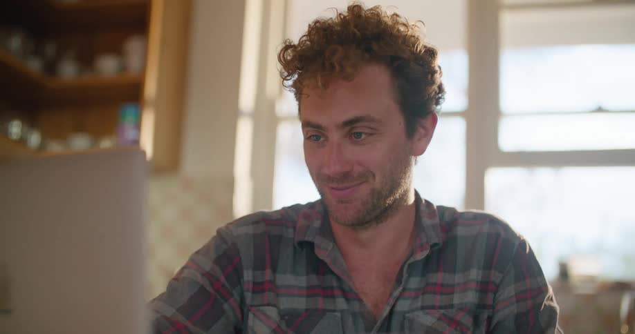 A man greets people on a video conference