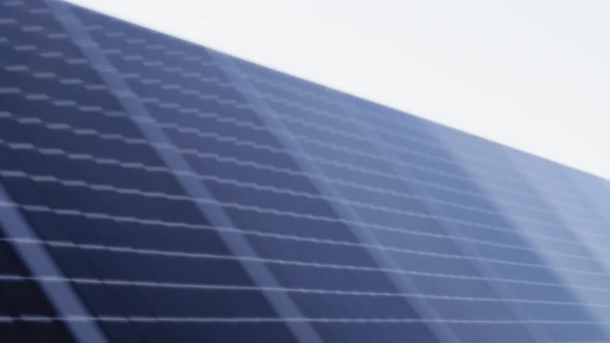 Low angle pass along row after row of high efficiency solar panels reflecting soft light