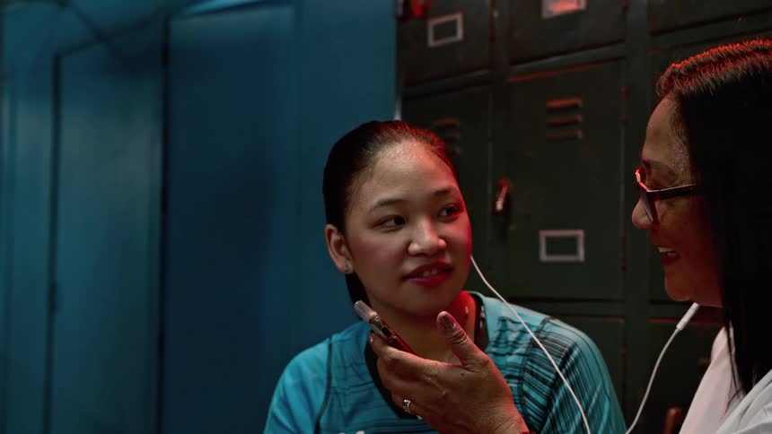 Two women listening to music with headphones