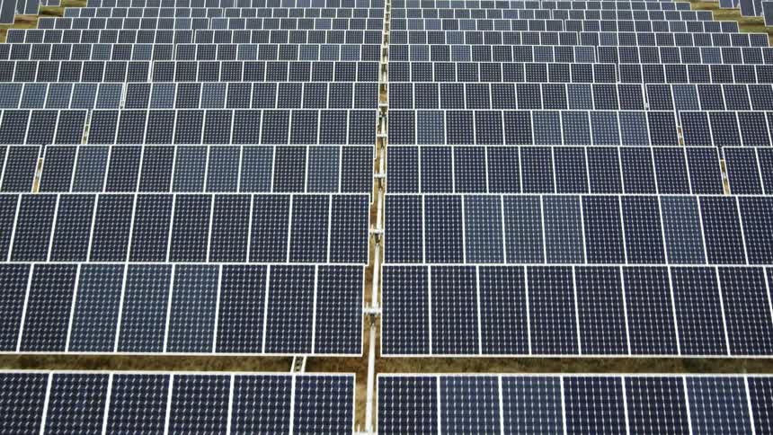 Traverse above hundreds of rows of solar panels installed at a solar power station