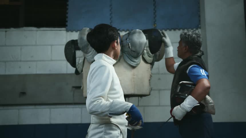 A man is helping a child train for a sport