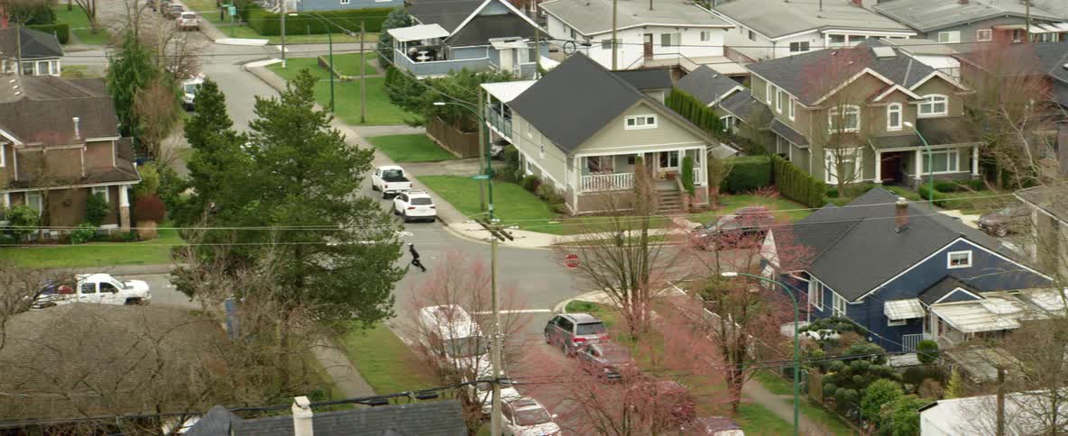 People running on the streets of a suburban neighborhood