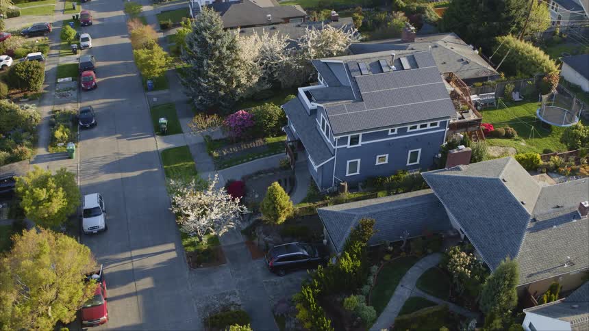 Birds eye view of a solar powered house in a nice suburban neighborhood