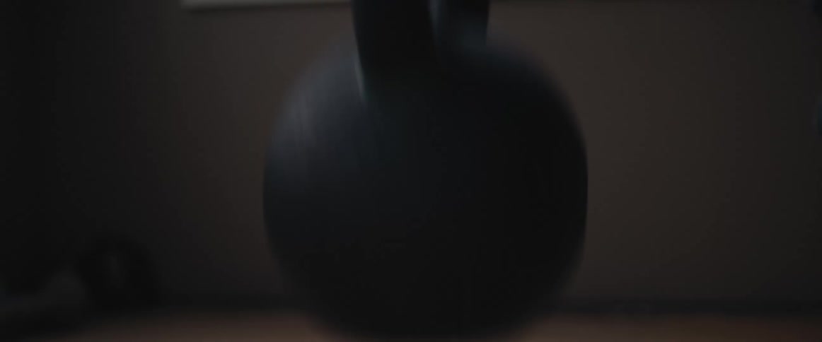 A person is lifting a kettle bell for exercise