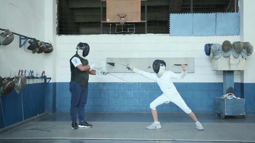 A man instructs a child in sword fighting