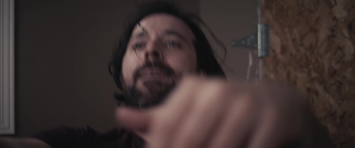 A man is exercising inside of a room during the day