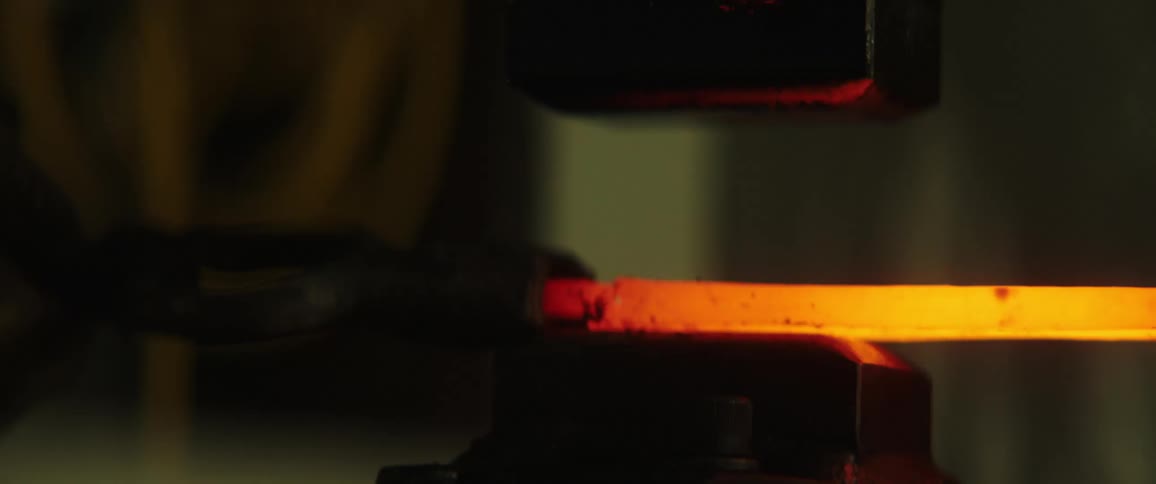 A person forges a piece of steel