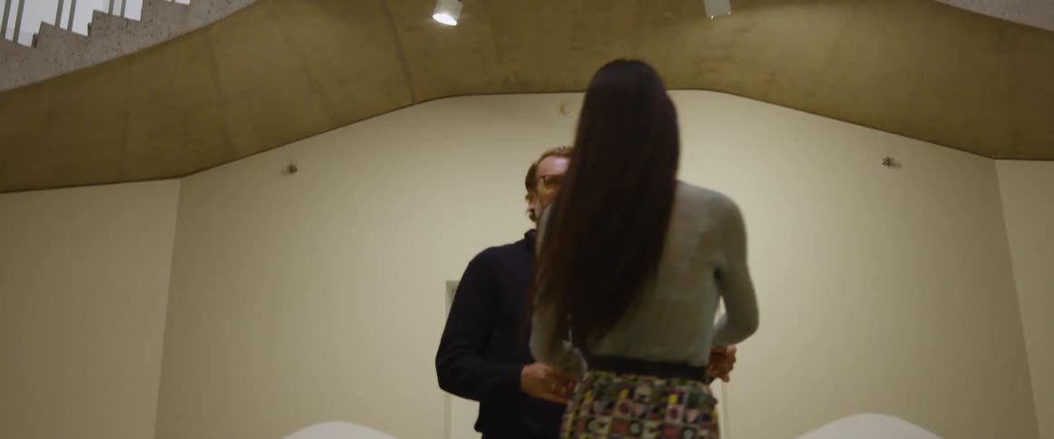 Couple on a date dancing inside a building