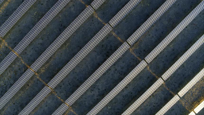 Birds eye twist of double tall solar panel arrays on a solar farm