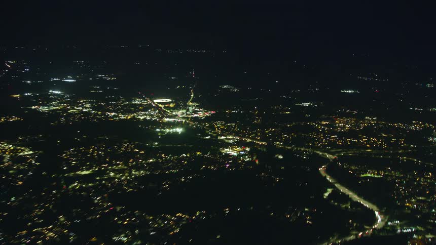 Traffic is streaming in and out of Portland Oregon in this night time aerial time lapse passing over the city at night
