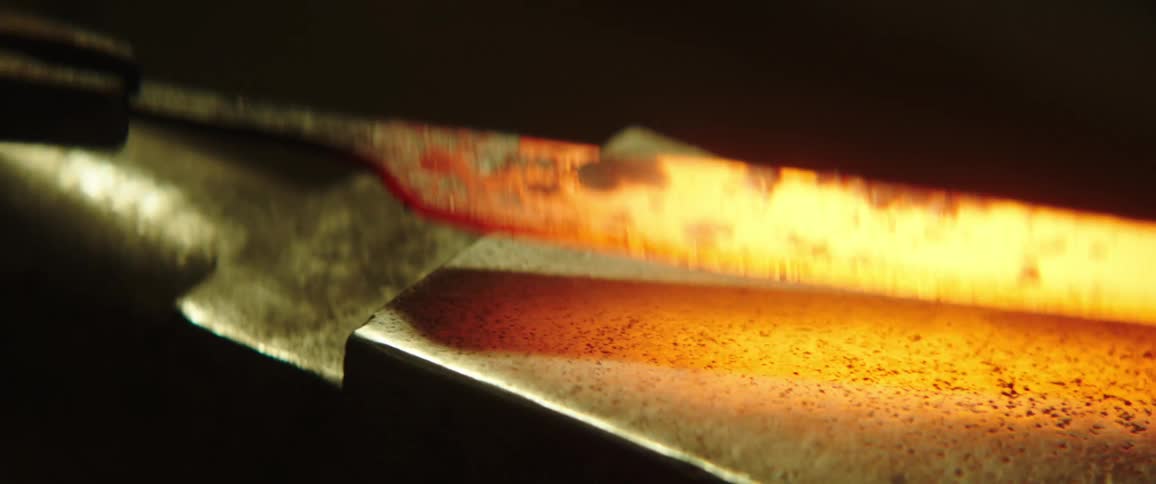 Forging hot metal