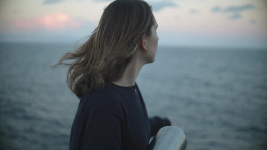 A portrait of a woman near the ocean