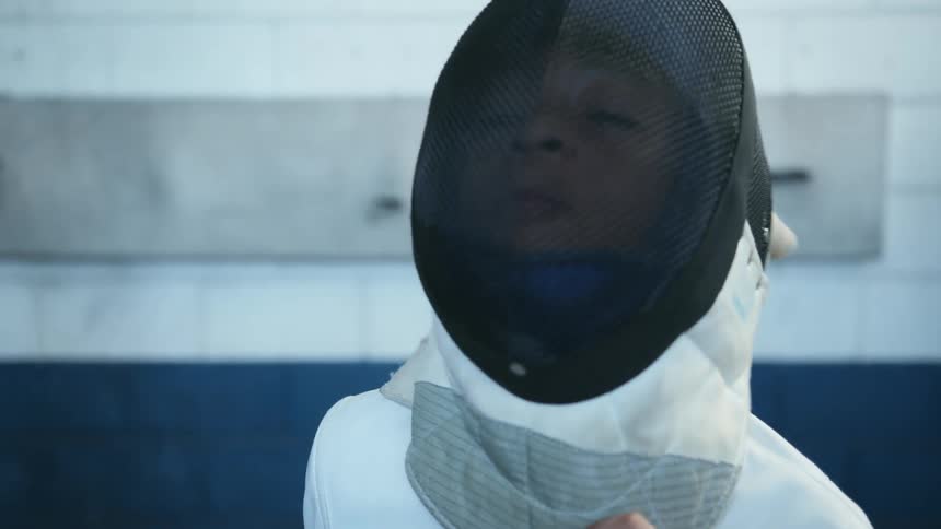Child wearing fencing gear