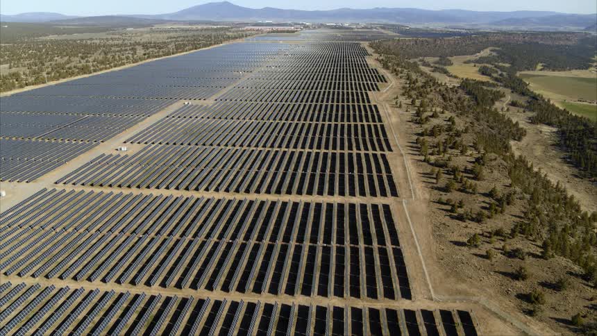 A vast solar power station stretches on for miles producing megawatts of electricity