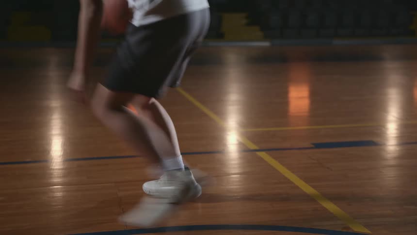 A woman playing basketball on a court