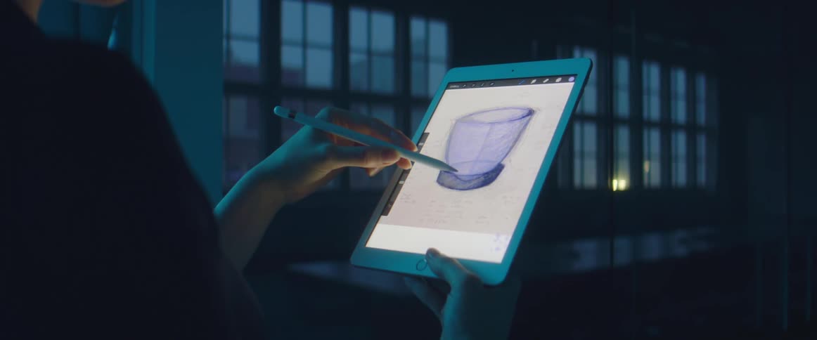 A woman draws on a tablet