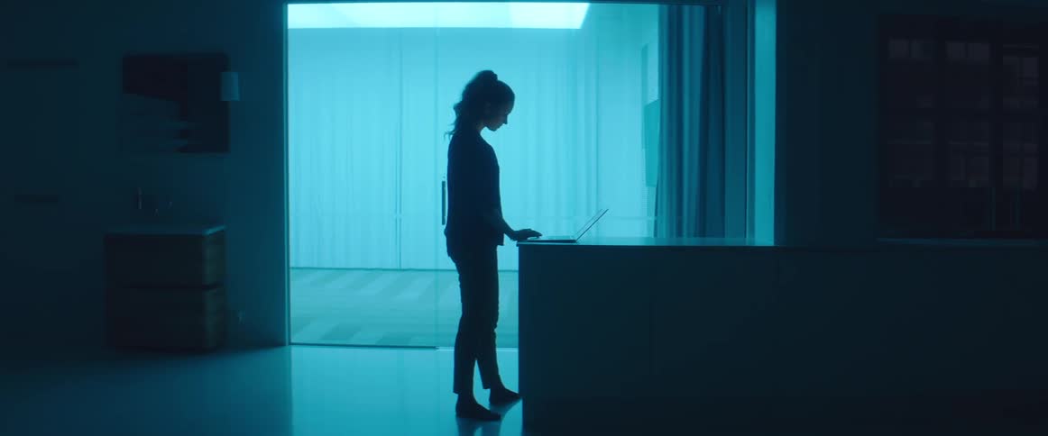 A woman typing on a laptop