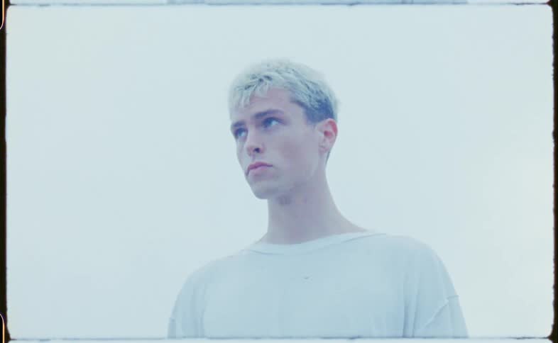 Young pale man wearing a white shirt standing on a white background