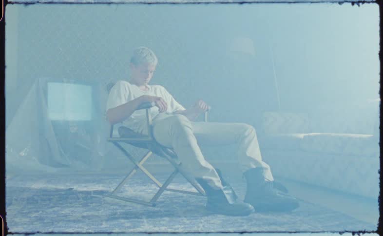 A man lays back to rest in the chair