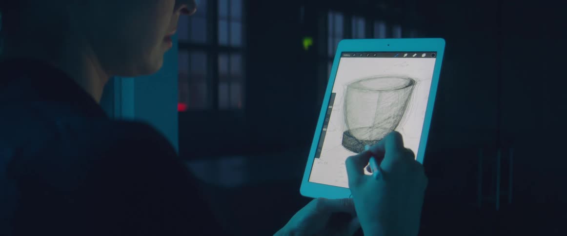 A woman draws on a tablet