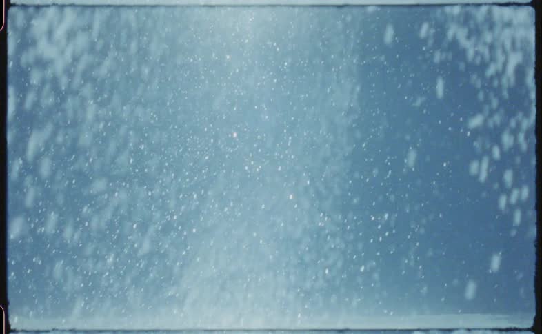 Snow falling down quickly outside in a very snowy area